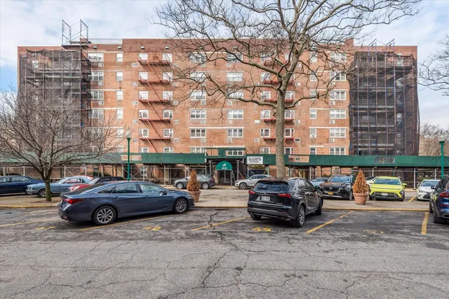 a city street lined with parked cars and buildings
