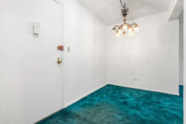 a view of a hallway with a chandelier