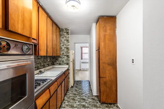a kitchen with a stove a sink and a refrigerator