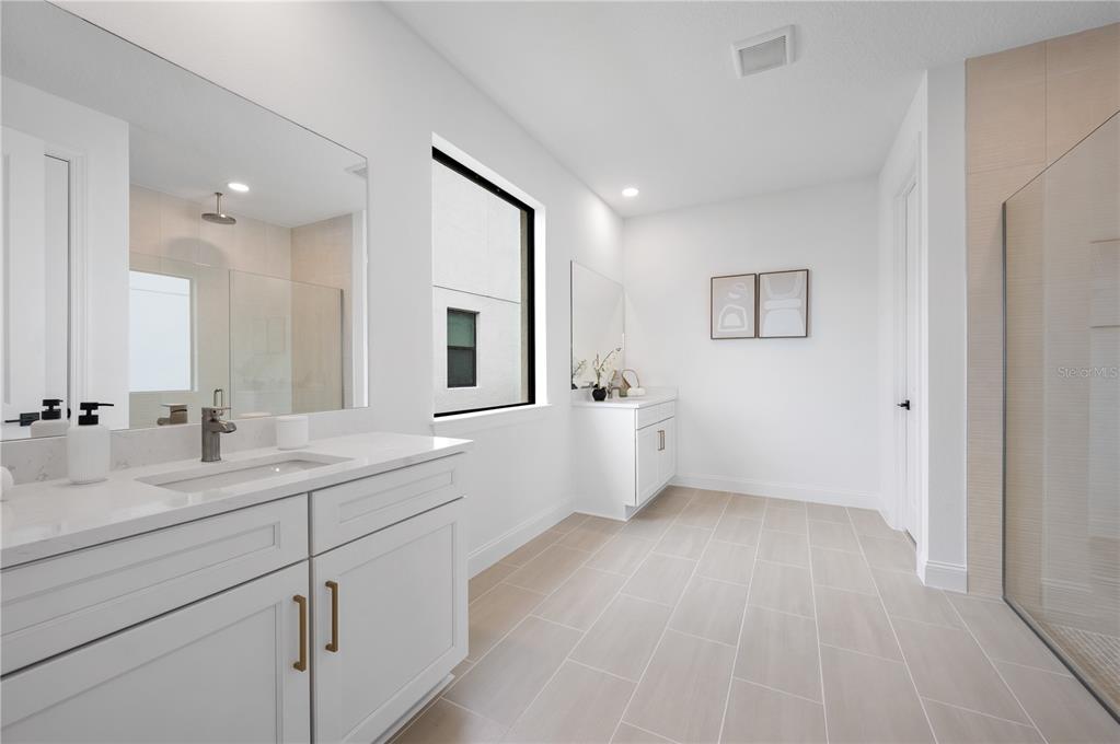 5856 Freestone Circle Apollo Beach, FL 33572 - Photo 19 of 33 a spacious bathroom with a double vanity sink a mirror and a bathtub