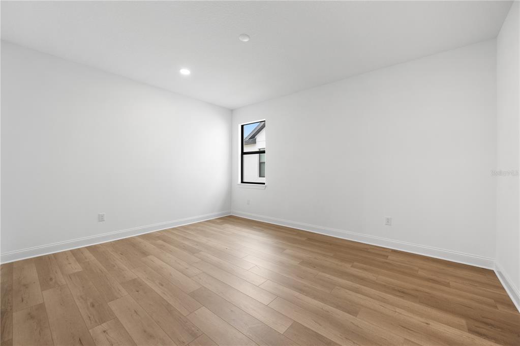 5856 Freestone Circle Apollo Beach, FL 33572 - Photo 23 of 33 an empty room with wooden floor and windows