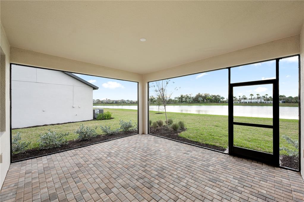 5856 Freestone Circle Apollo Beach, FL 33572 - Photo 5 of 33 a view of a house with a yard and floor to ceiling window and wooden floor