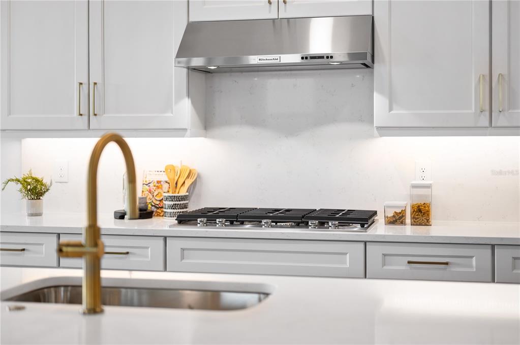 5856 Freestone Circle Apollo Beach, FL 33572 - Photo 10 of 33 a kitchen with a stove and a white wooden cabinets