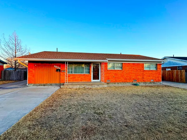 a front view of house with an outdoor space and parking