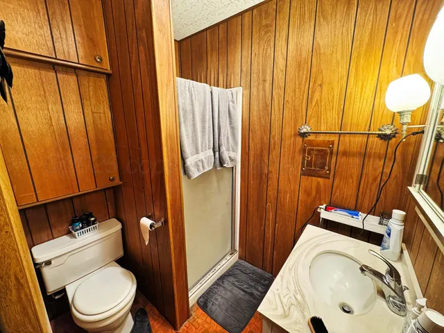 a bathroom with a toilet a sink and tub
