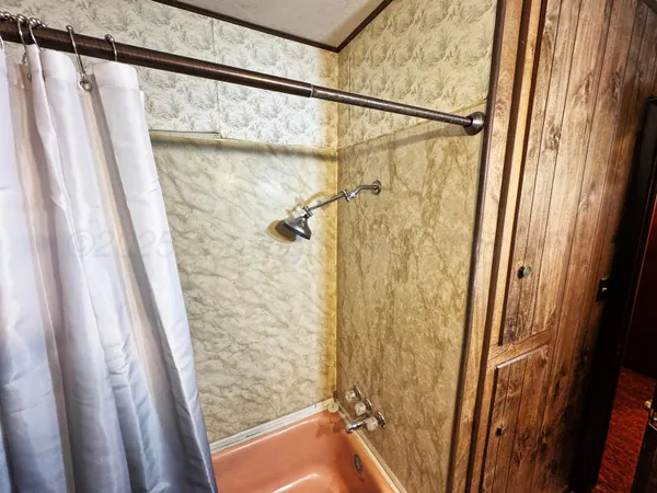 a bathroom with a shower and a tub