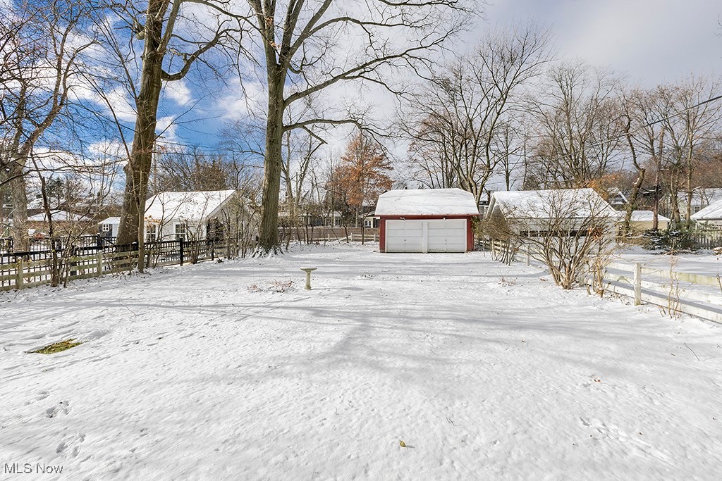 2596 Ashton Road Cleveland, OH 44118 - Photo 40 of 43 Yard layered in snow with an outbuilding and a garage