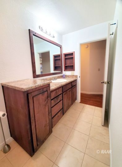 419 South Lorie Ann Street Ridgecrest, CA 93555 - Photo 10 of 27 a bathroom with a sink a mirror and a bathtub