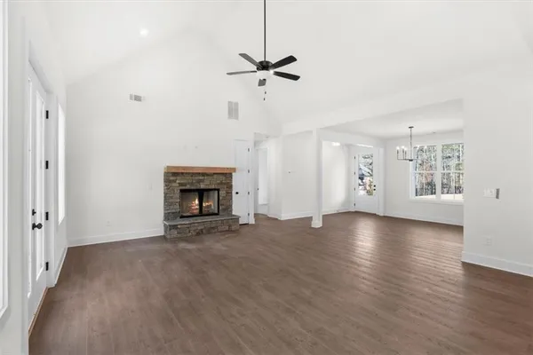 a view of an empty room with a fireplace and a window