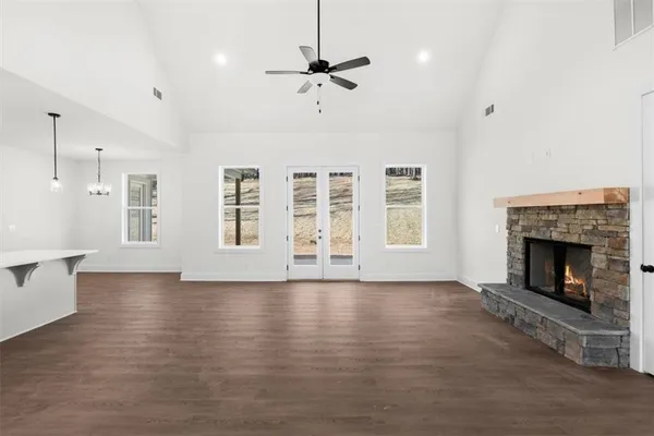 a view of an empty room with a fireplace and a window