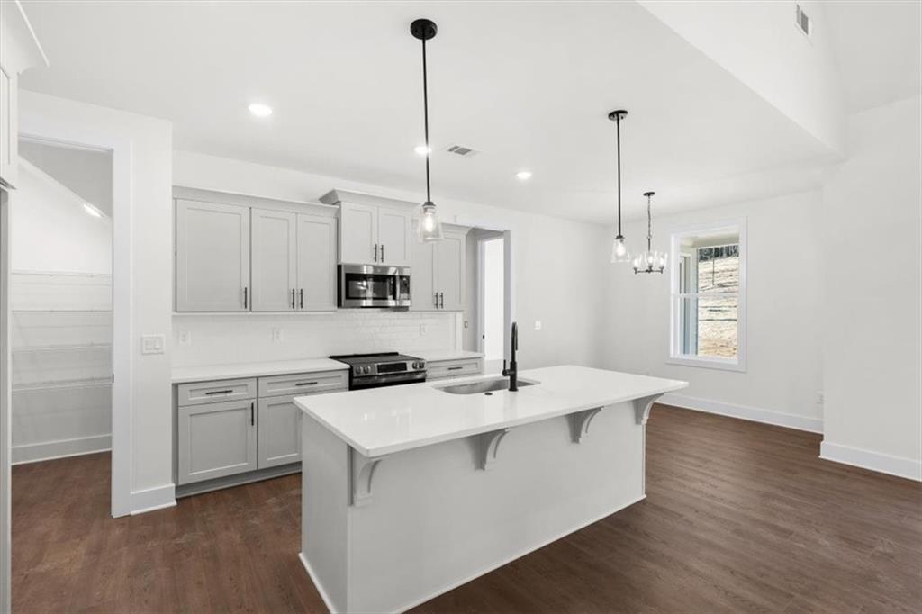7 Everwood Court Rome, GA 30161 - Photo 16 of 55 a kitchen with a sink a stove a refrigerator and a window