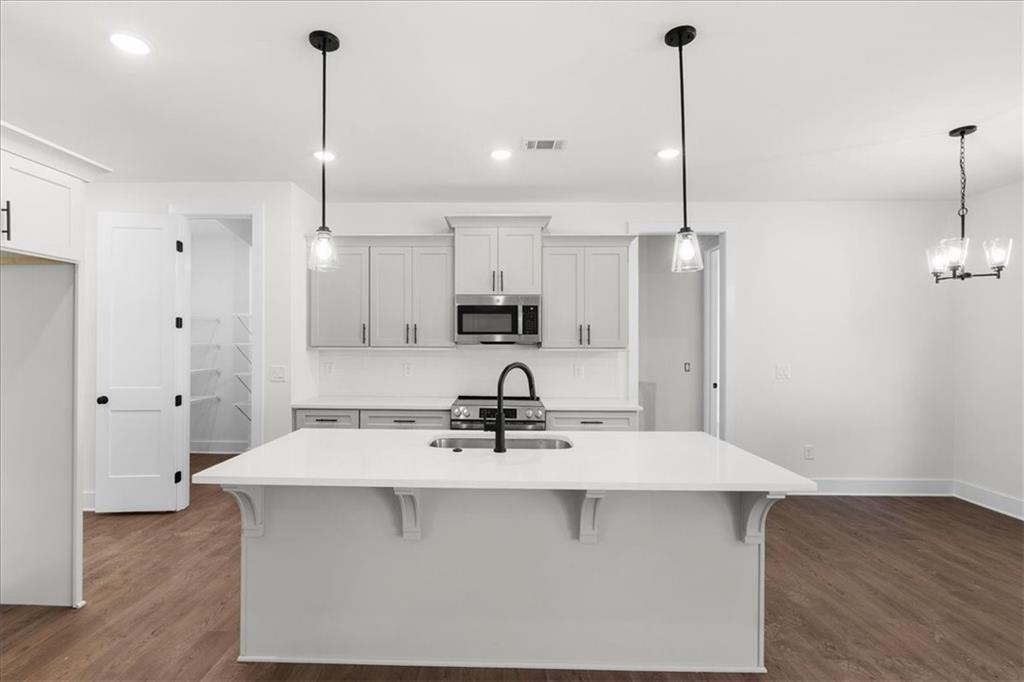 7 Everwood Court Rome, GA 30161 - Photo 17 of 55 a kitchen with kitchen island a sink stainless steel appliances and cabinets