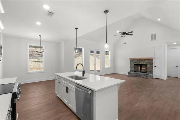 a view of a kitchen with a sink wooden floor and a window