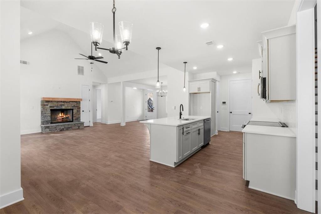 7 Everwood Court Rome, GA 30161 - Photo 22 of 55 a large white kitchen with a stove a sink a refrigerator and a fireplace