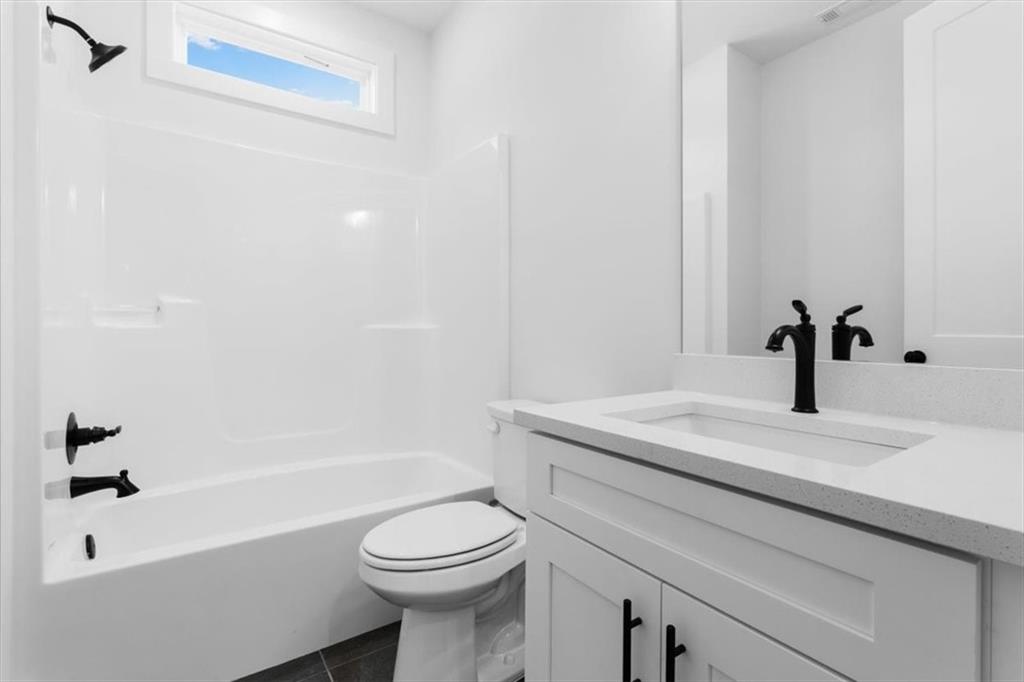 7 Everwood Court Rome, GA 30161 - Photo 31 of 55 a bathroom with a granite countertop sink a toilet and bathtub