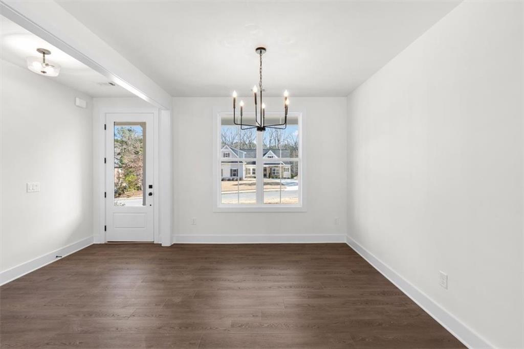 7 Everwood Court Rome, GA 30161 - Photo 9 of 55 an empty room with wooden floor chandelier and windows