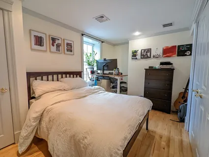 a bedroom with a bed and a view of kitchen
