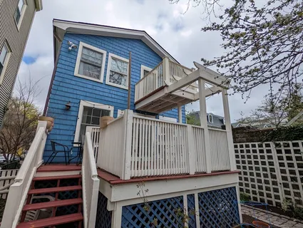 a view of a roof deck with wooden floor and fence