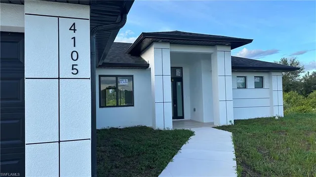 a view of a front door and small yard