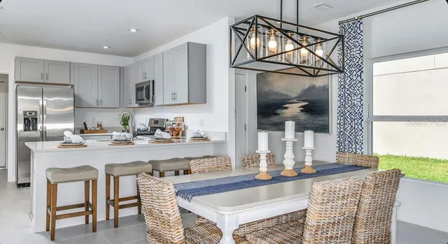 a kitchen with stainless steel appliances granite countertop a sink and a refrigerator