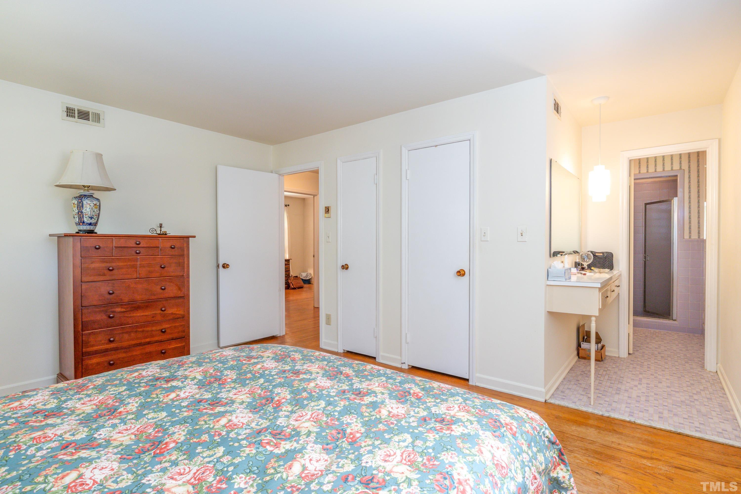 6201 Arnold Road Raleigh, NC 27607 - Photo 24 of 46 a bedroom with a bed and a dresser in it