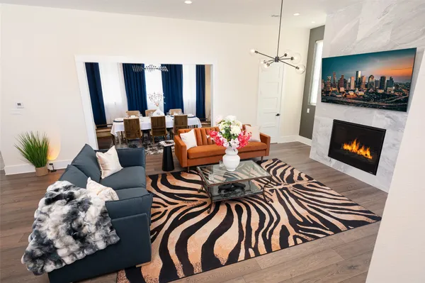 a living room with furniture fireplace and flat screen tv