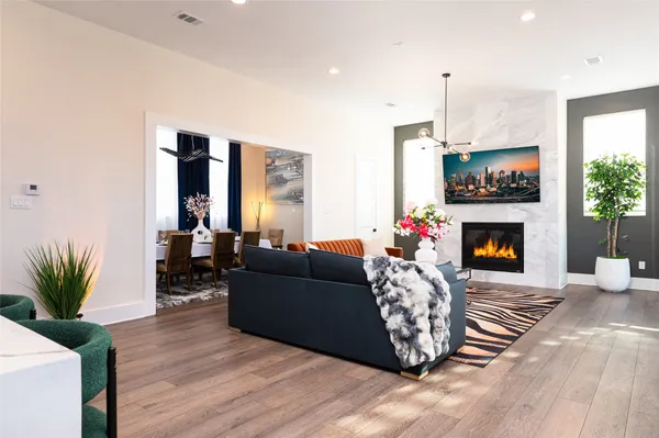 a living room with furniture a fireplace and a flat screen tv