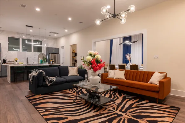 a living room with furniture and wooden floor