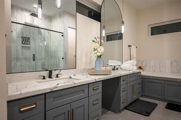a bathroom with a double vanity sink and a mirror