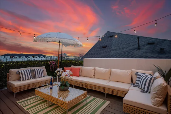 a terrace of a house with couches and city view