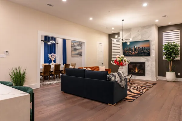 a living room with furniture a fireplace and a flat screen tv