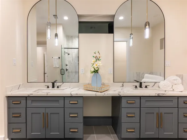 a bathroom with a double vanity sink and a mirror