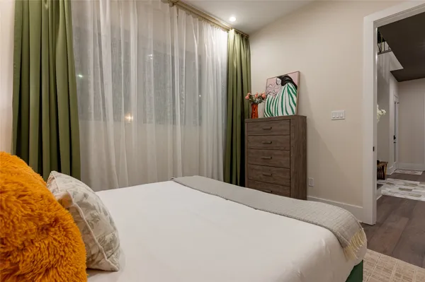 a bedroom with a bed and a flat tv screen