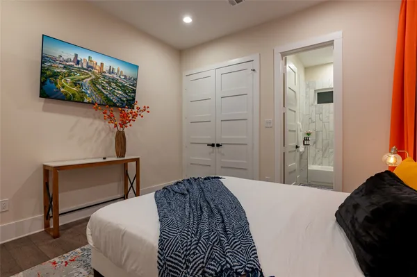 a bedroom with a bed and a painting on the wall