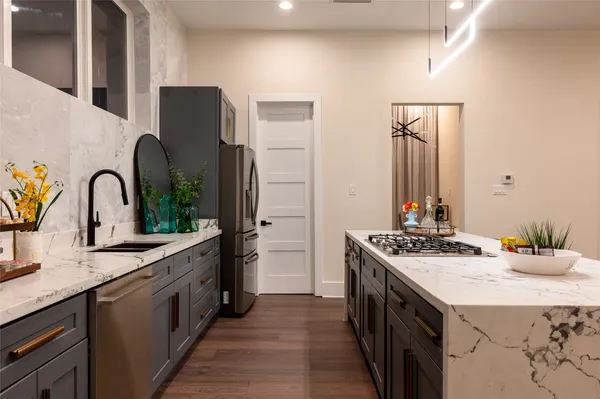 a kitchen with stainless steel appliances a sink stove and refrigerator