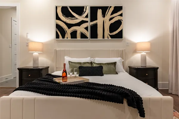 a bedroom with a bed and lamp