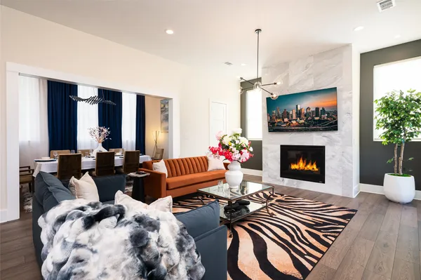 a living room with furniture a flat screen tv and a fireplace