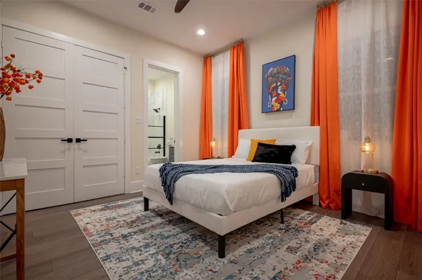 a bedroom with a bed and wooden floor