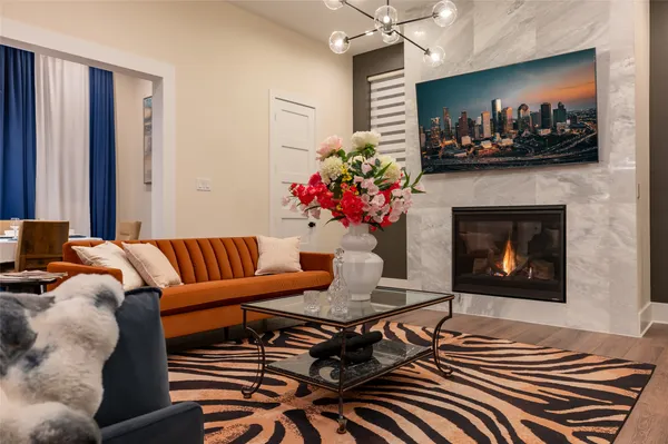 a living room with furniture a flat screen tv and a fireplace