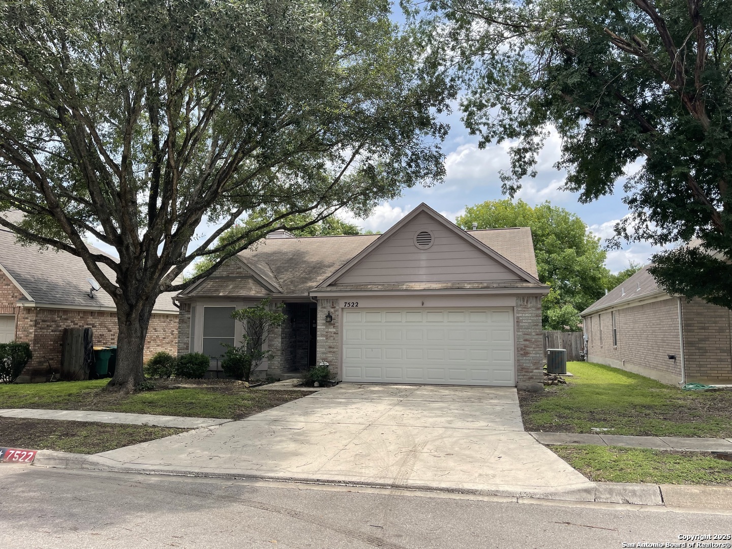7522 Sutters Mine Converse, TX 78109 - Photo 1 of 18 a front view of a house with a garden and trees