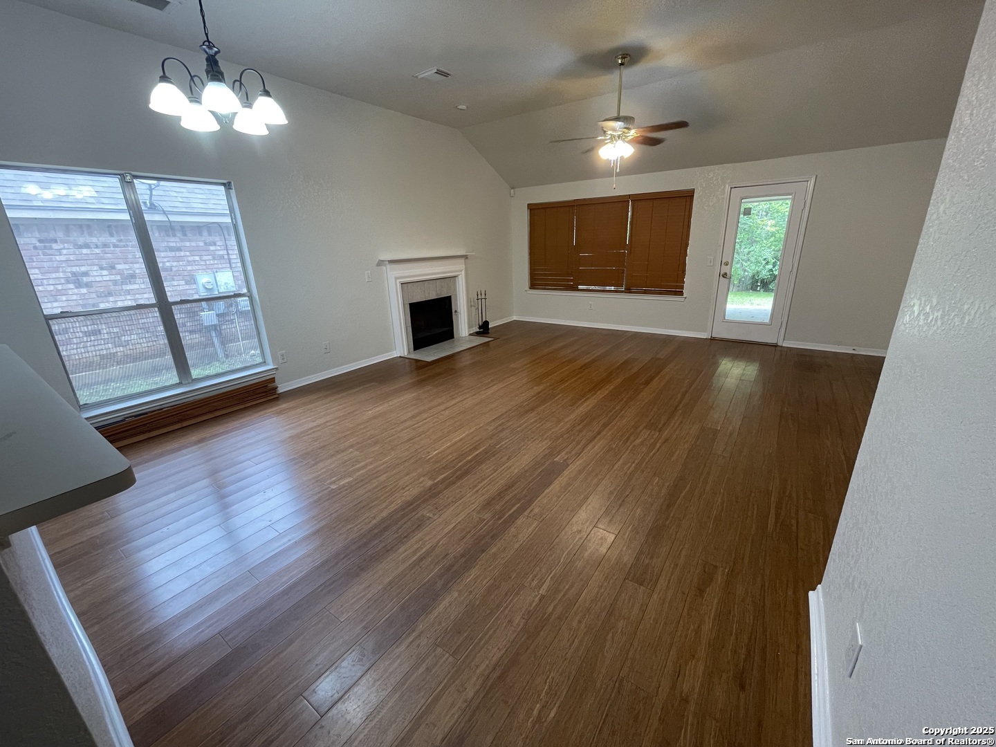 7522 Sutters Mine Converse, TX 78109 - Photo 12 of 18 a view of an empty room with window and wooden floor