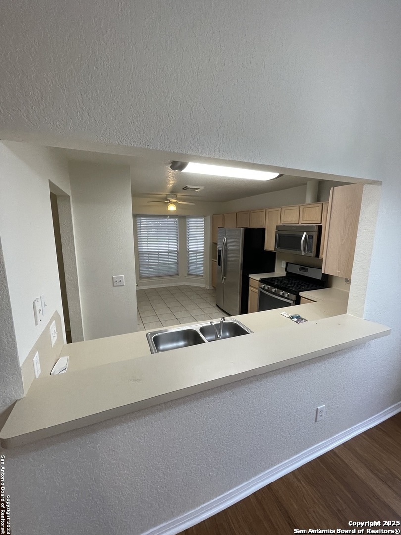 7522 Sutters Mine Converse, TX 78109 - Photo 7 of 18 a view of kitchen with stainless steel appliances kitchen island sink and refrigerator