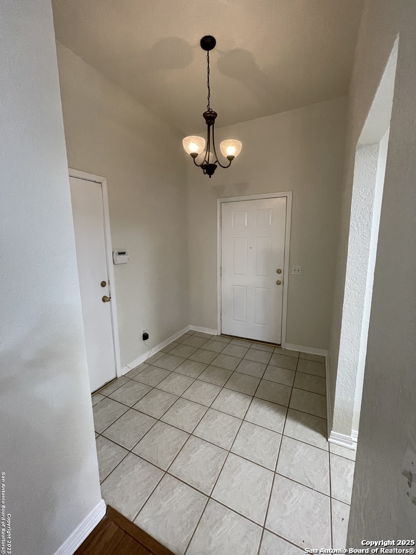 7522 Sutters Mine Converse, TX 78109 - Photo 8 of 18 a view of a hallway with a chandelier fan