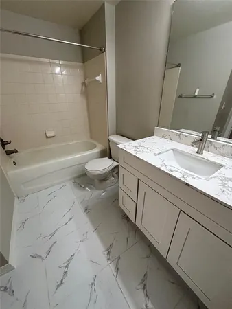 a bathroom with a sink a mirror and a toilet
