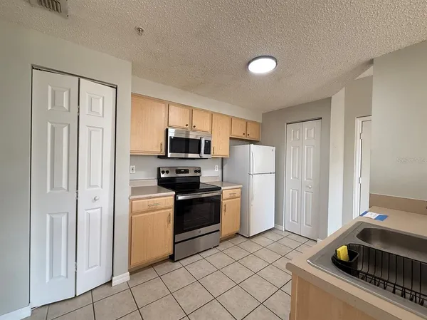 a kitchen with stainless steel appliances granite countertop a stove and a refrigerator