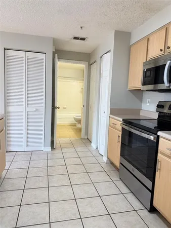 a view of a kitchen with a sink and a stove top oven