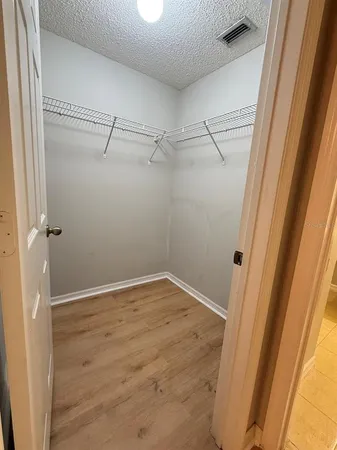 a bathroom with a granite countertop sink a toilet and mirror