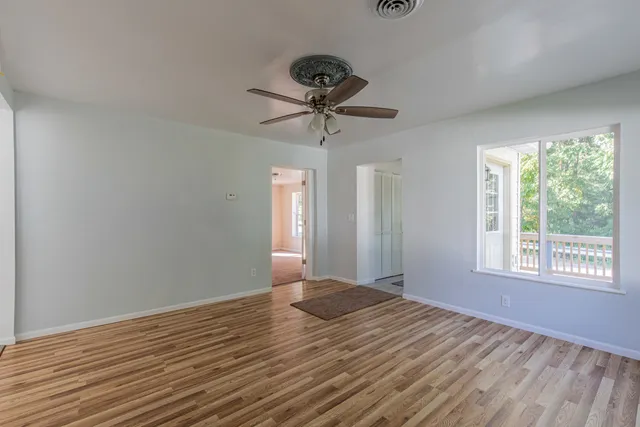 a view of a livingroom with a window and a ceiling fan