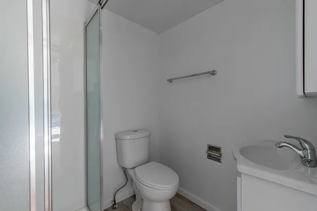 a white toilet sitting next to a bathroom sink