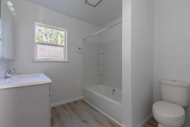 a bathroom with a sink toilet and vanity